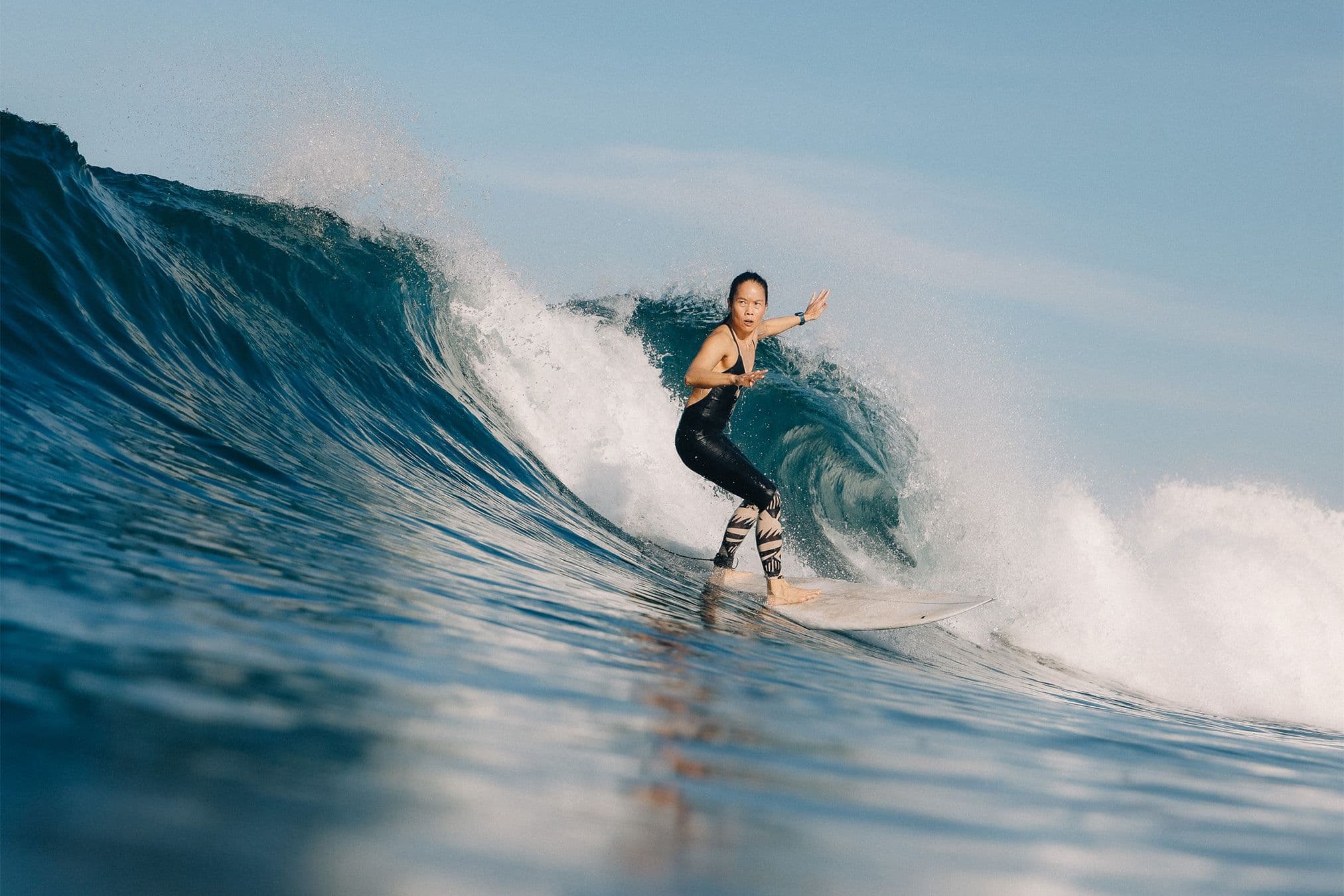 bonnie tsui dropping into a wave in playa guiones, costa rica