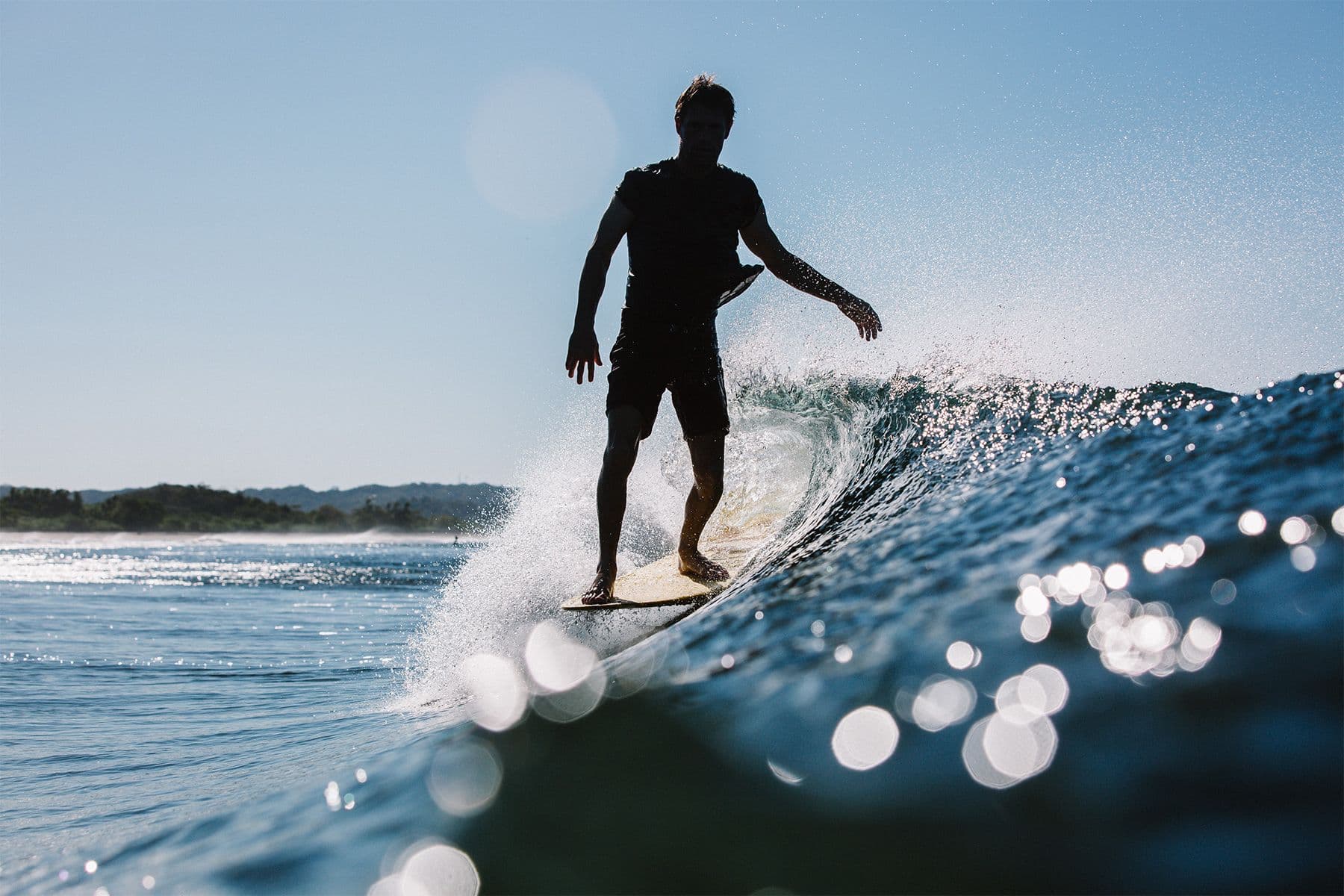 surfer hanging five on a longboard in costa rica photographed by saltshots